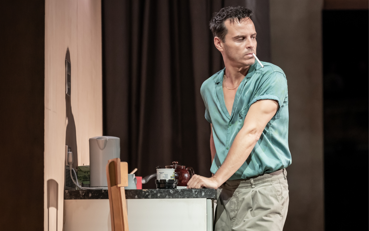 Actor Andrew Scott, with cigarette in his mouth looking over his shoulder back towards the stage