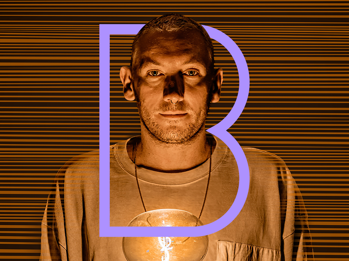 Man washed in golden light with a single letter B in purple surrounding them. 