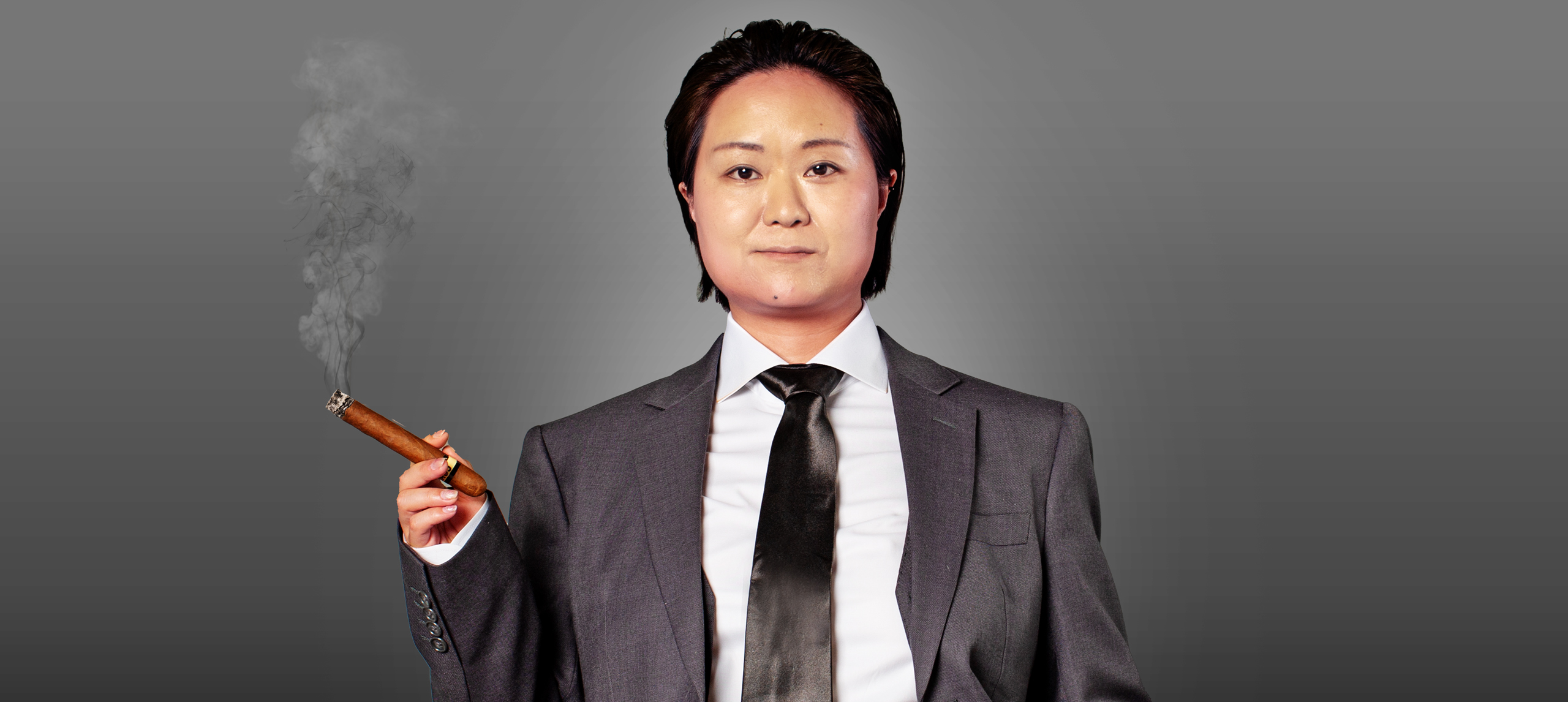 He Huang dressed in a suit with a cigar