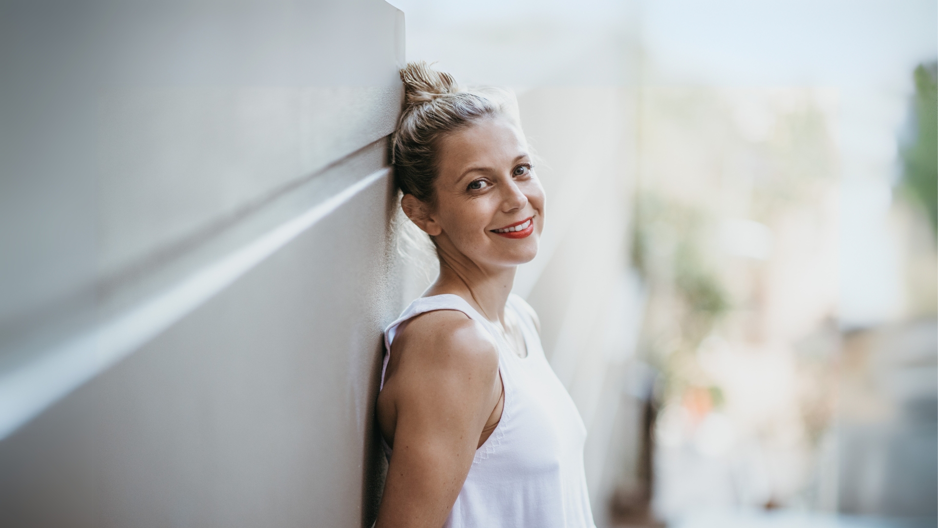 A woman in active wear looks into the camera