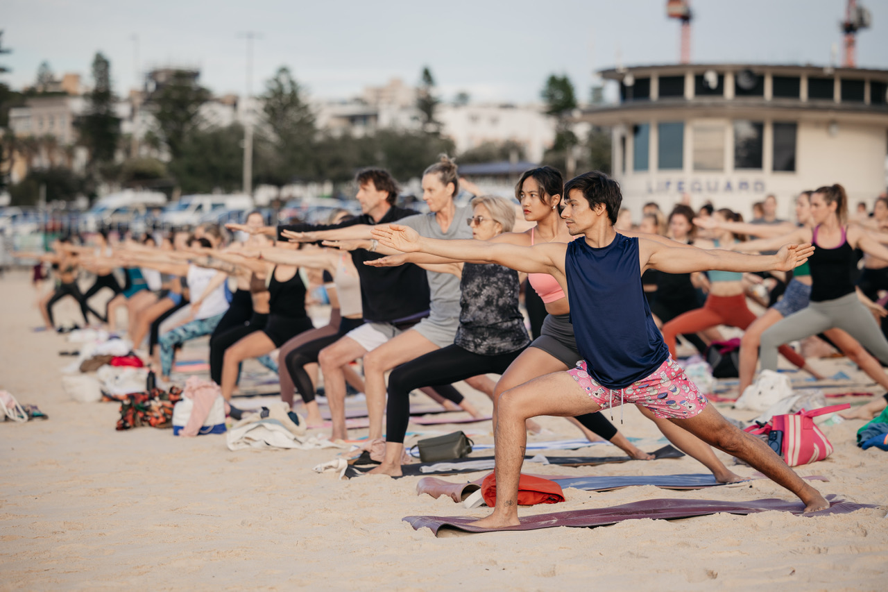 Folks doing yoga on the beach