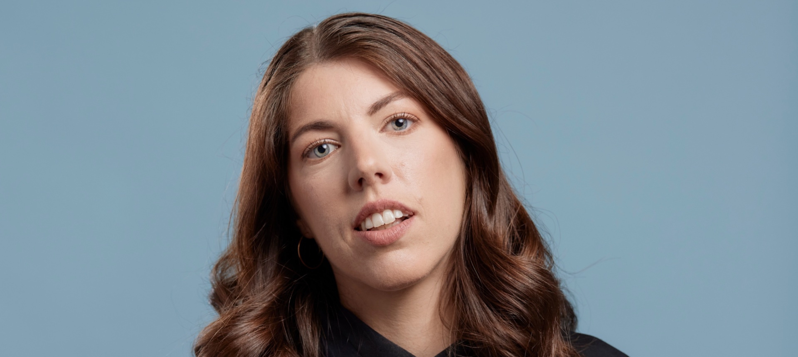 Alex Ward headshot on blueish grey background