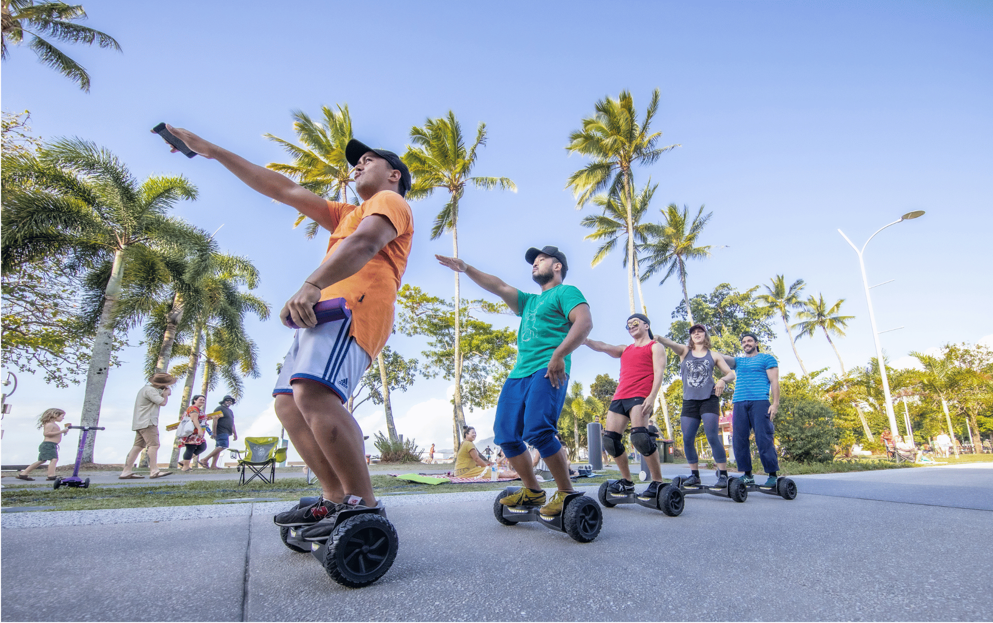 Five dancers in a row, standing on hover boards