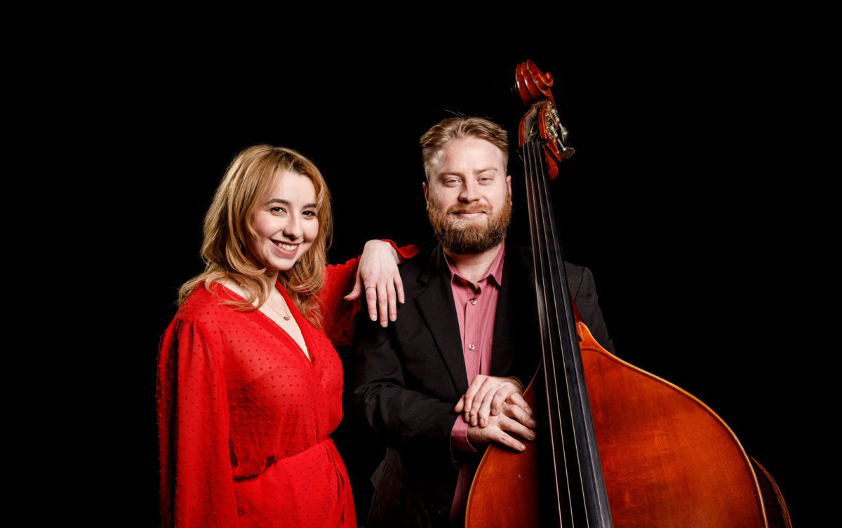 male and female jazz musicians dressed well with a double bass