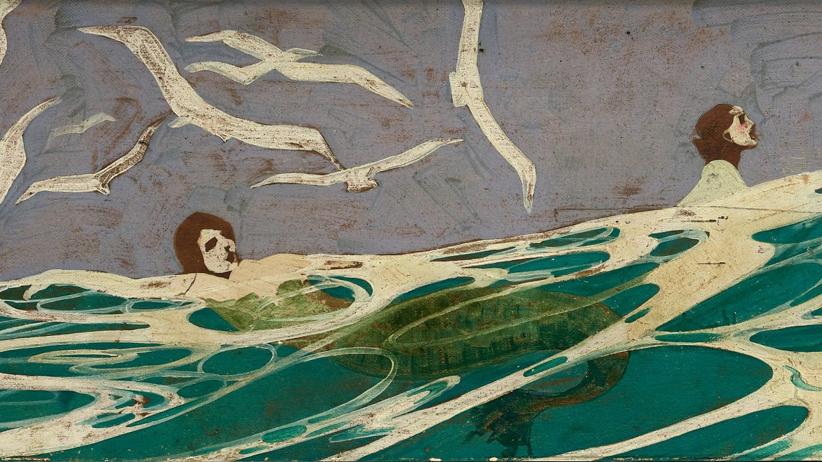 A detail of one of Souter's murals depicting white skinned mermaids with red hair frolicking in the ocean beneath a flock of seagulls. 