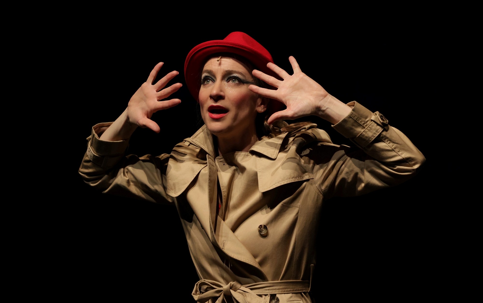 Image of women in beige trench coat and red hat